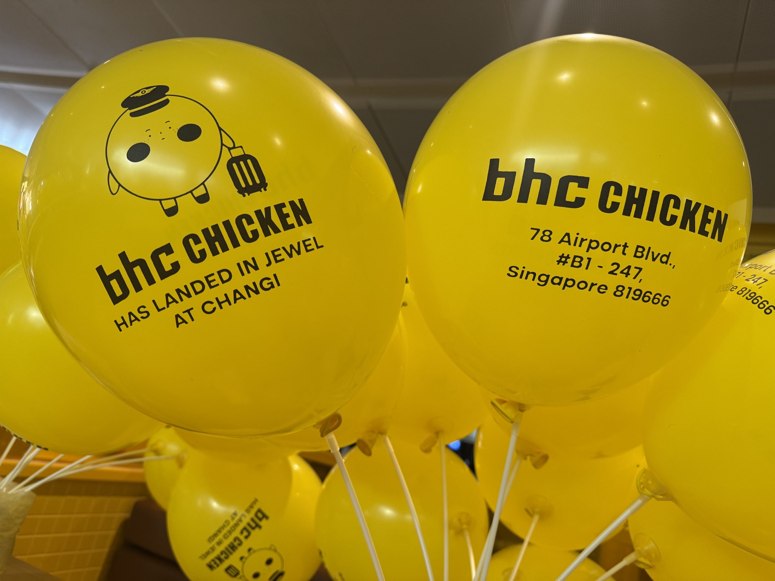Custom printed BHC Chicken yellow balloons on sticks
