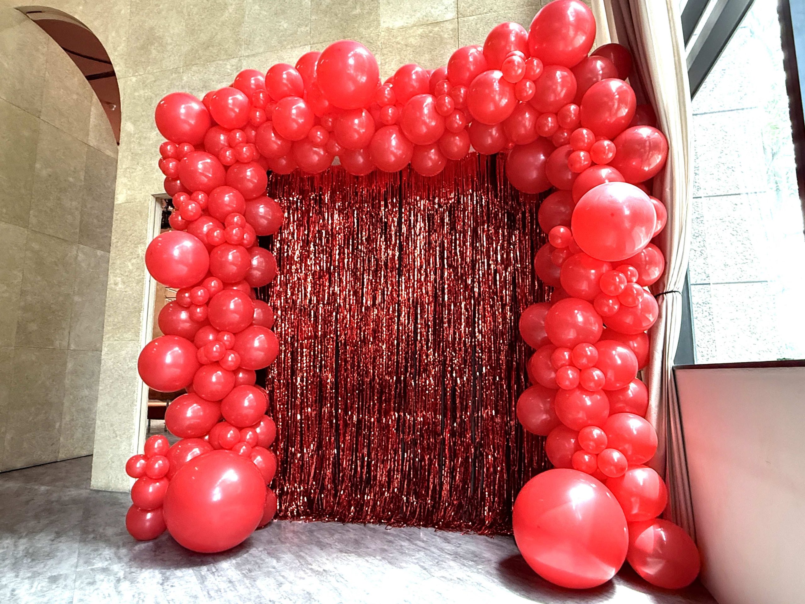 Red organic balloon arch shimmer backdrop event Balloon Decorations Singapore