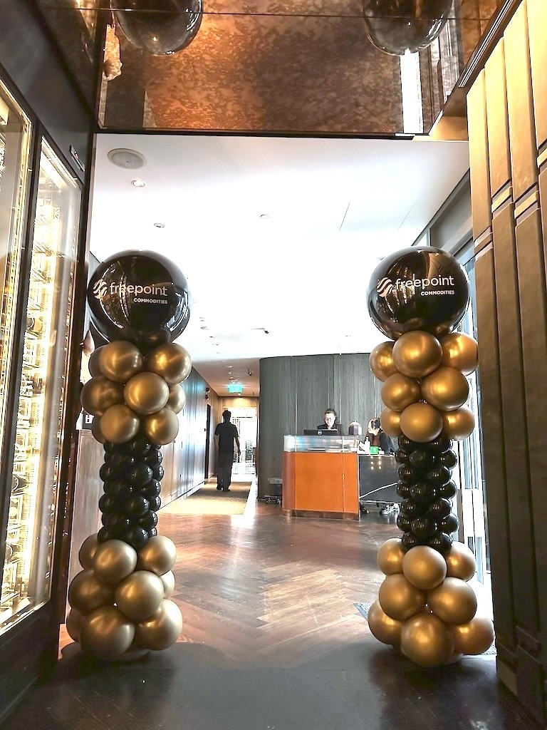 Branded black and gold balloon columns for a corporate event balloon decoration Singapore