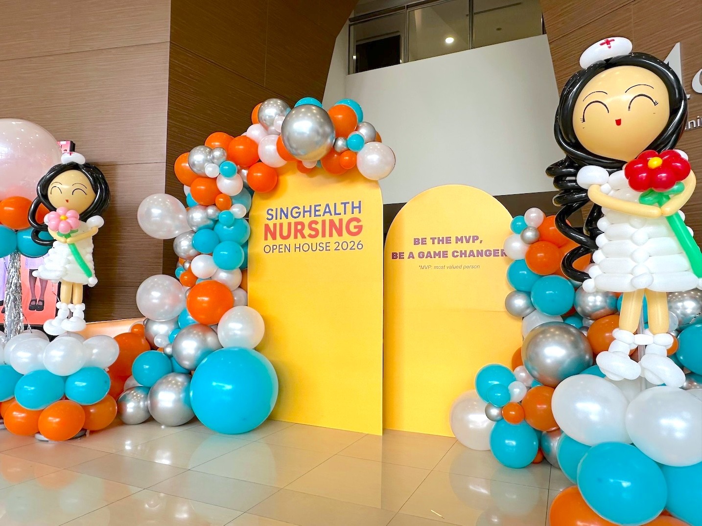 Organic balloon arch with nurse sculpture corporate open house balloon decorations Singapore