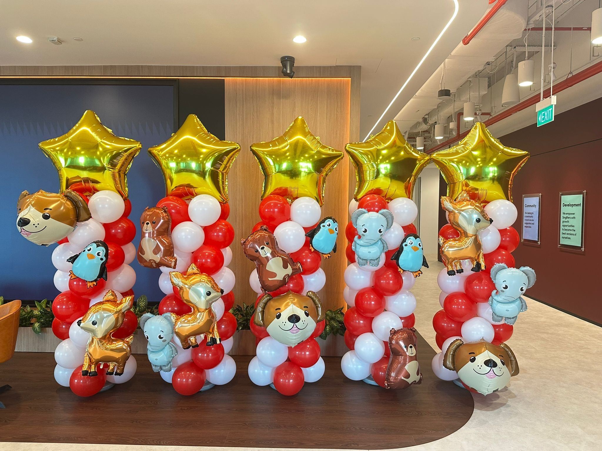 Red and white balloon columns with animal foil balloons corporate event balloon decorations Singapore