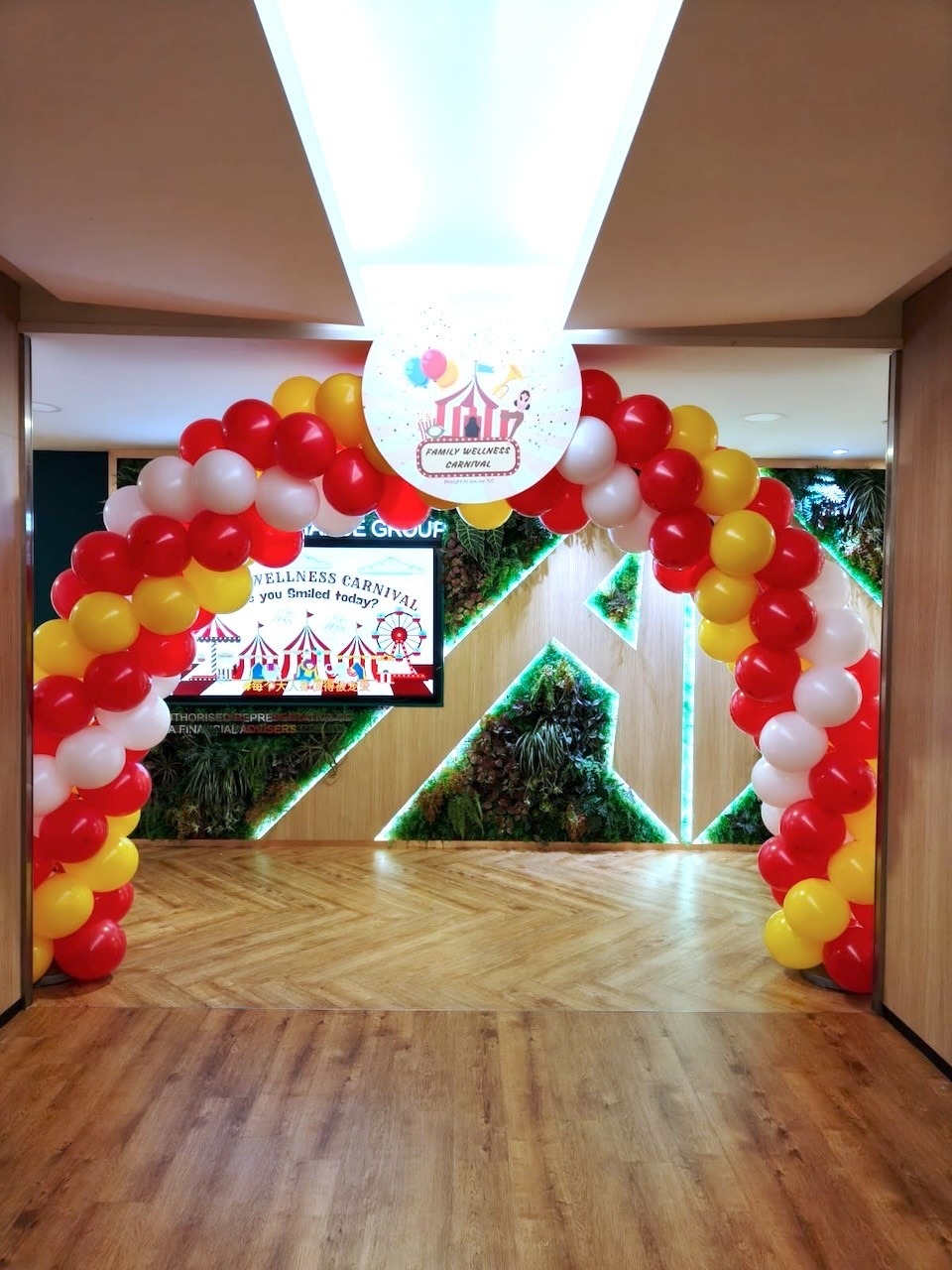 Red yellow white balloon arch for corporate wellness carnival balloon decorations Singapore