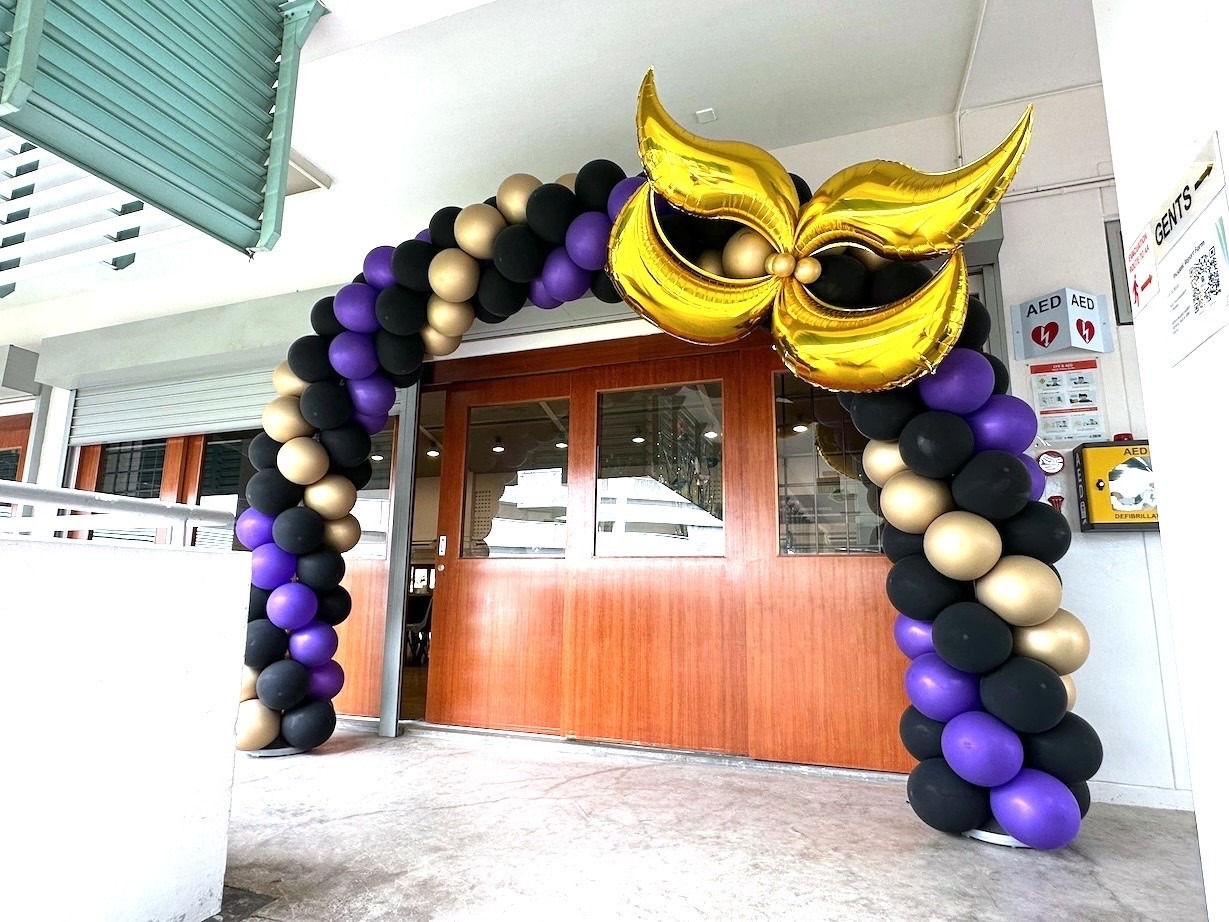 Masquerade theme balloon arch in gold purple and black for Singapore themed party