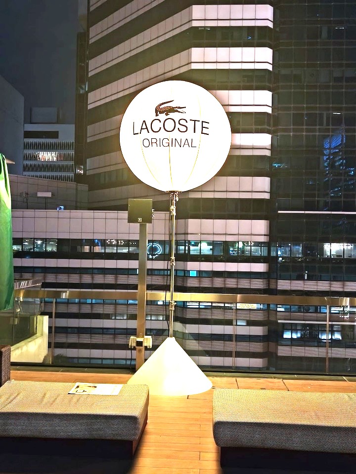 Branded lighted balloon stand at corporate rooftop event in Singapore