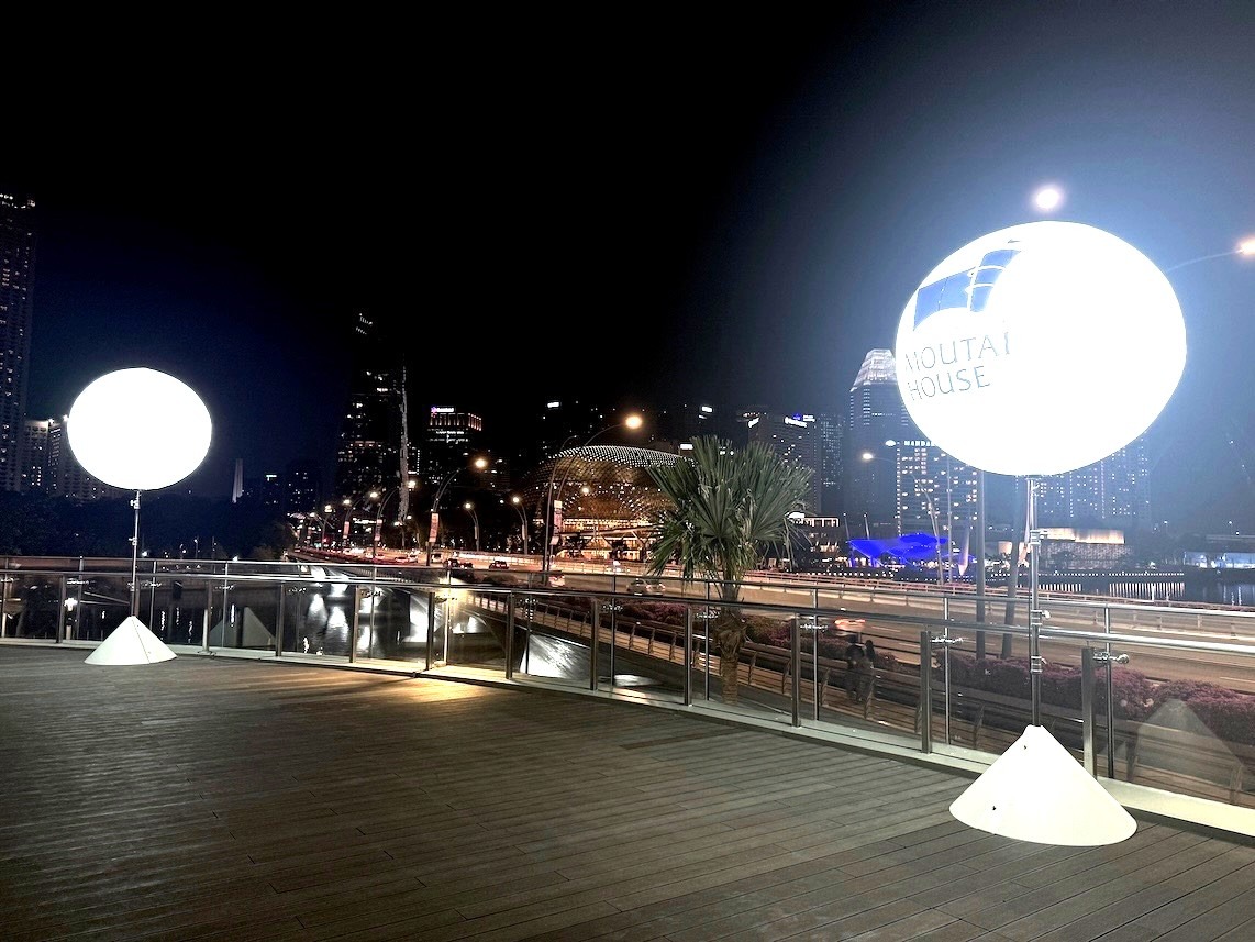Outdoor lighted balloon stand illuminating a night event in Singapore