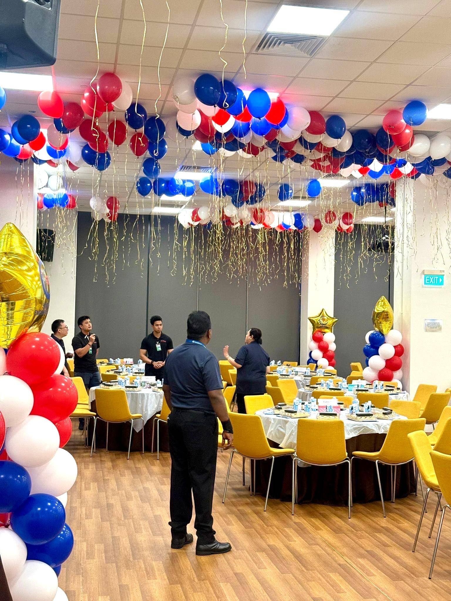 Red, white and blue helium balloon ceiling at a corporate dinner in Singapore