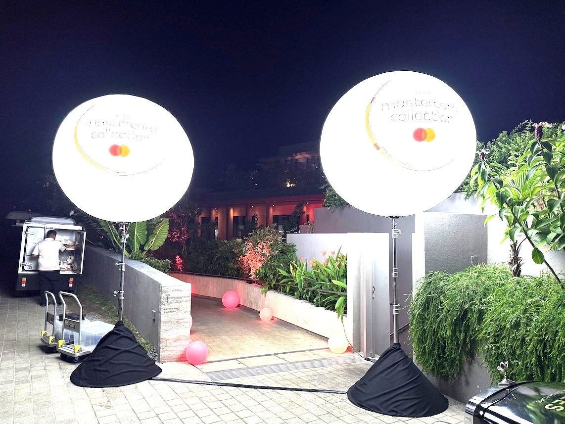 Lighted advertising balloon stands at corporate event entrance in Singapore