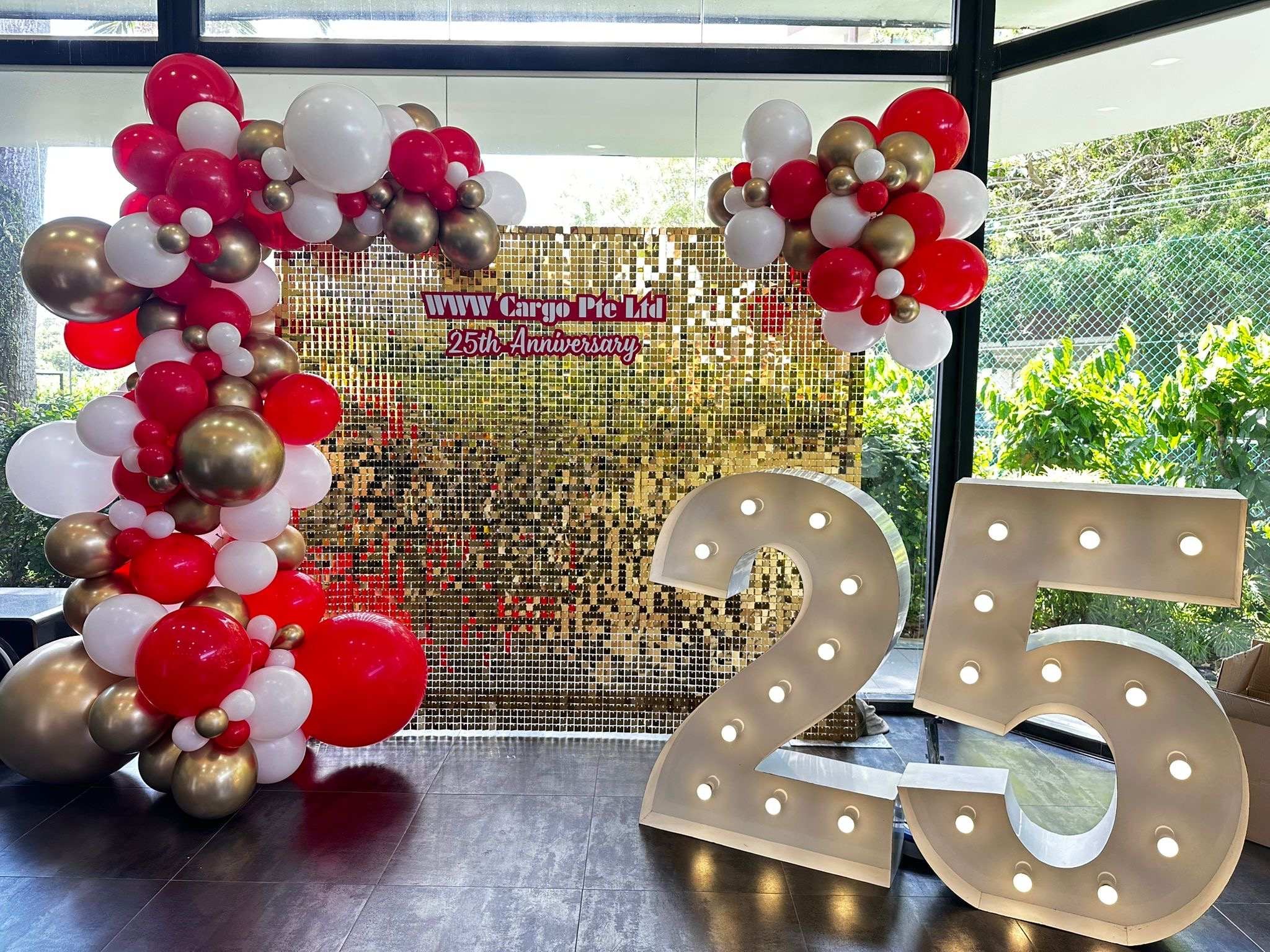 Organic balloon arch with sequin backdrop for a corporate anniversary in Singapore
