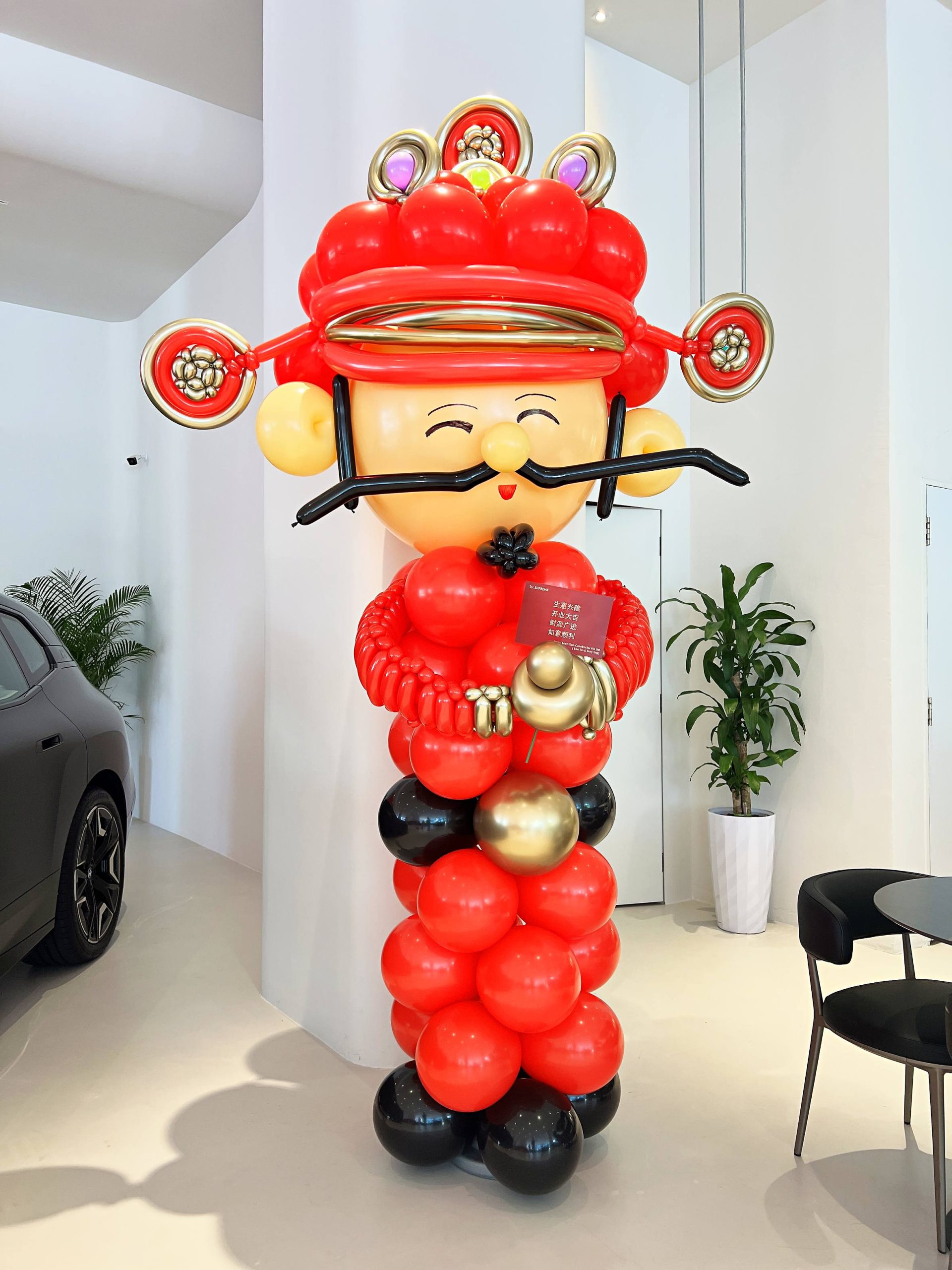 Caishen balloon sculpture at a car showroom