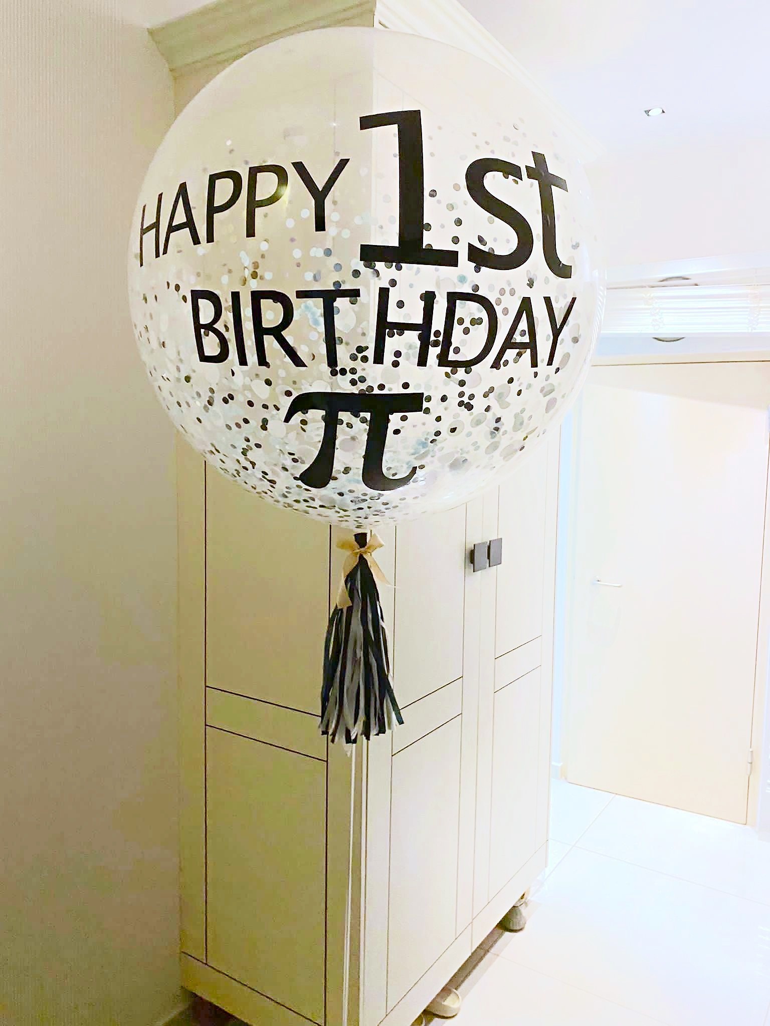 Personalised first birthday confetti balloon with a black tassel