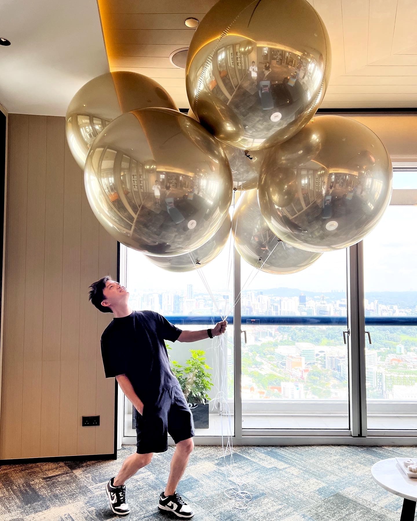 Large metallic gold spherical helium balloons inside a venue