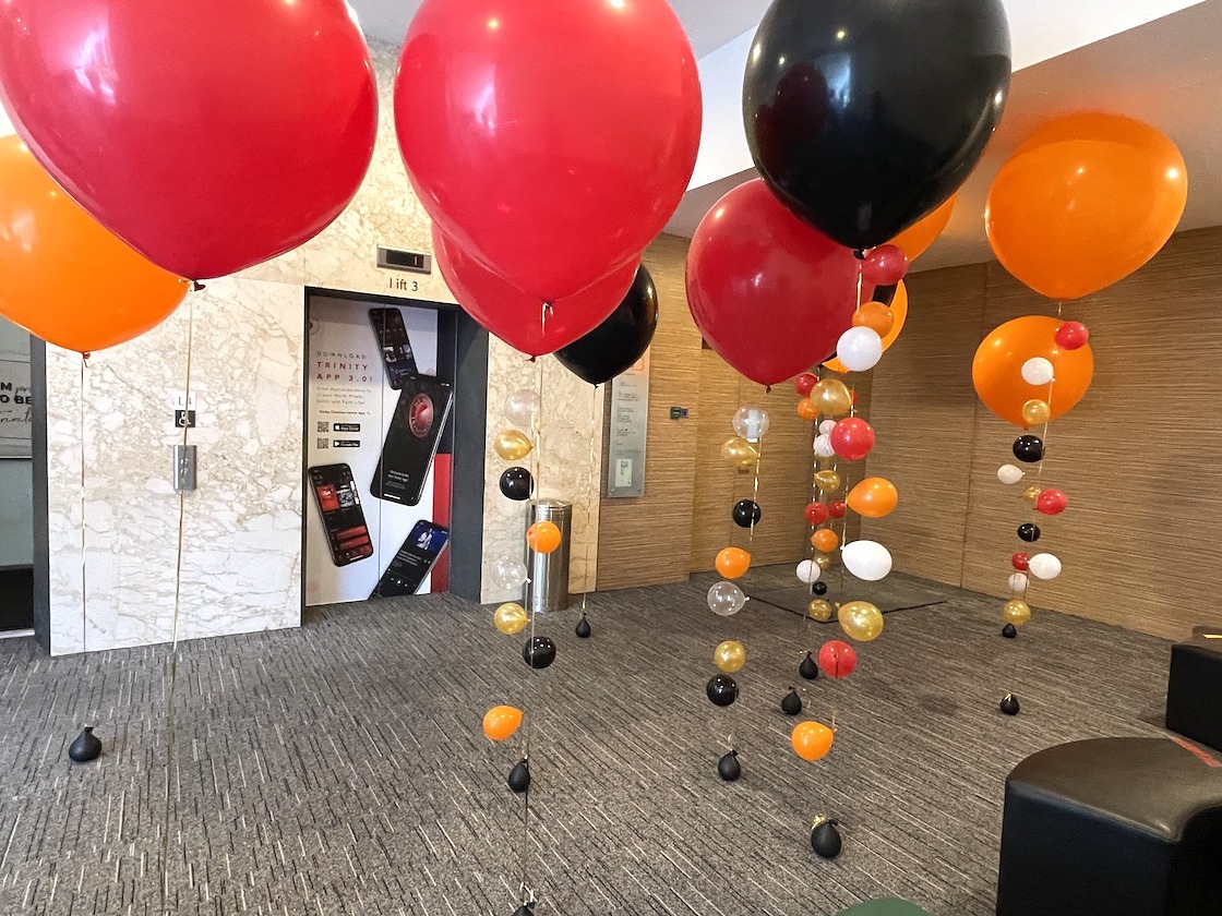 Red black and orange giant helium balloons with decorative tails