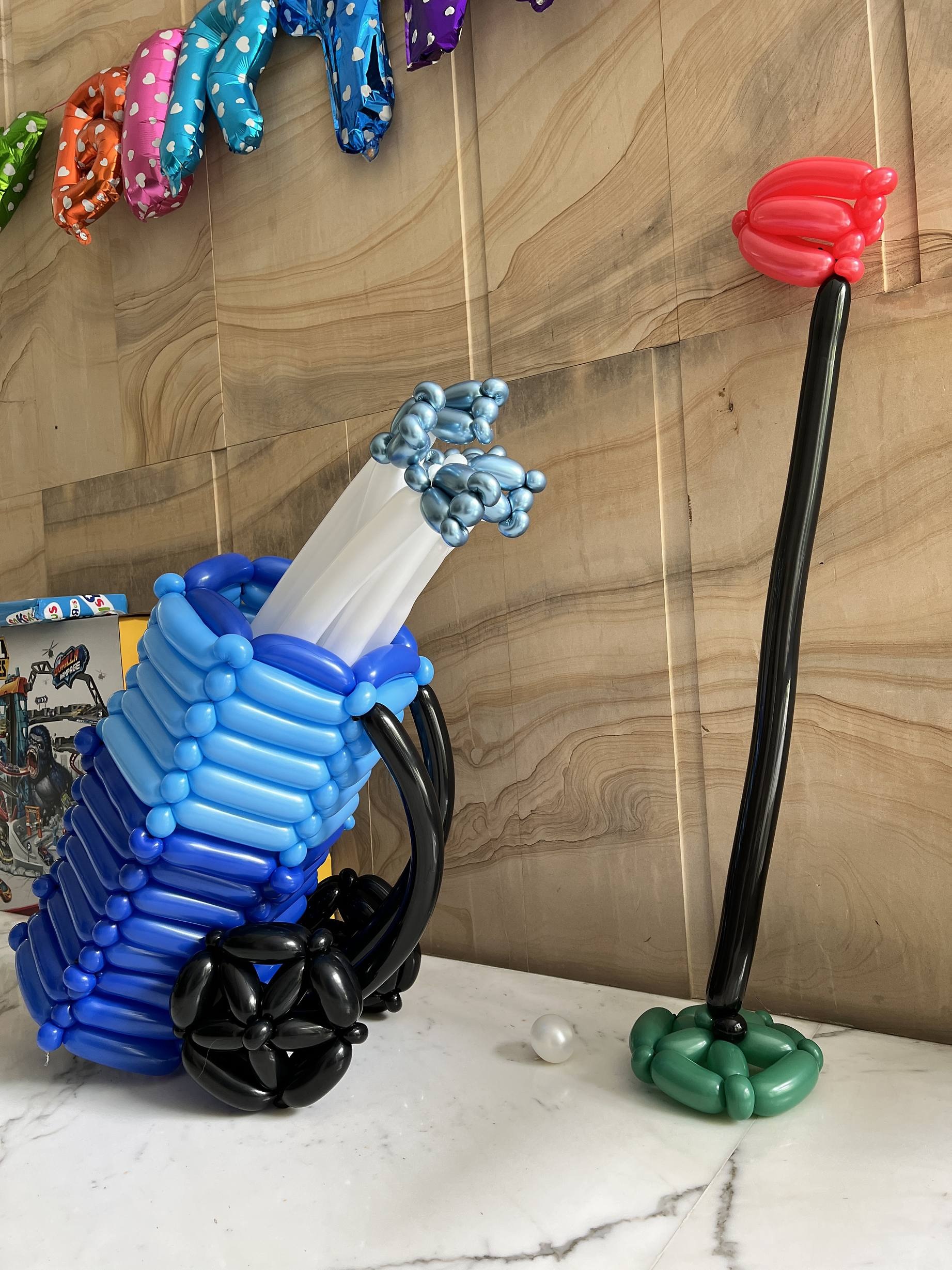 Blue golf bag and club balloon sculpture