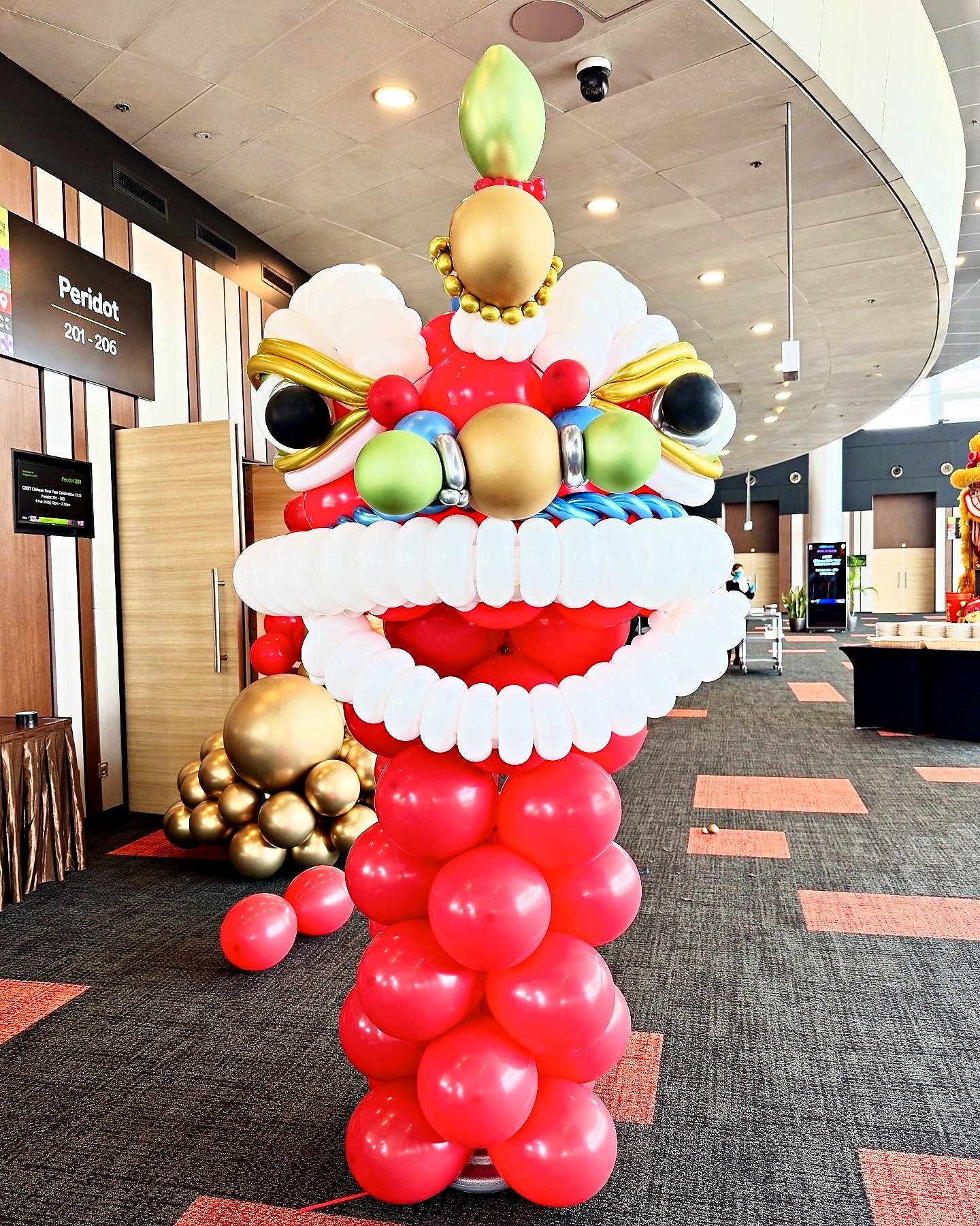 Red and gold lion dance head made from balloons