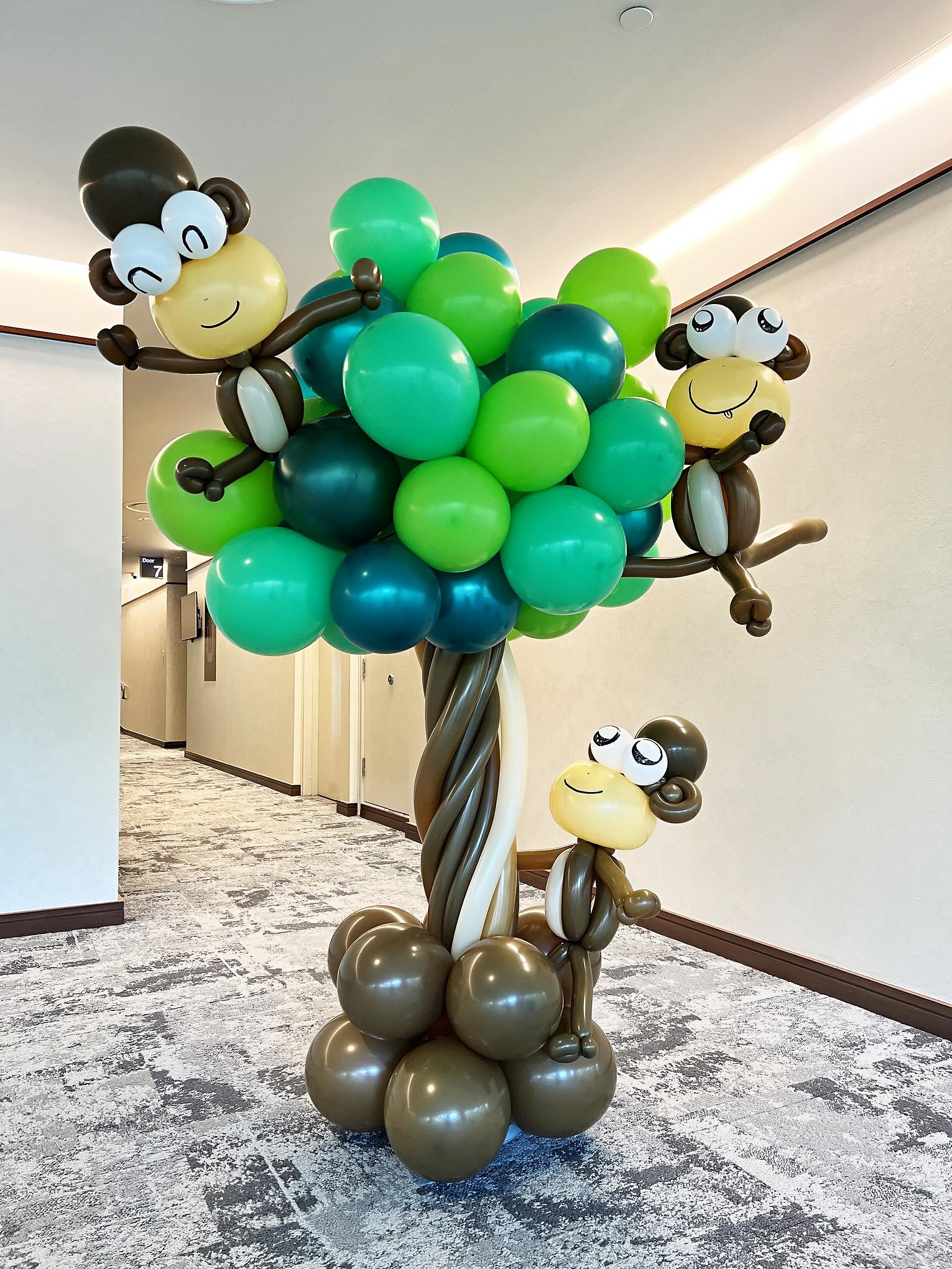 Monkey balloon figures climbing a balloon tree