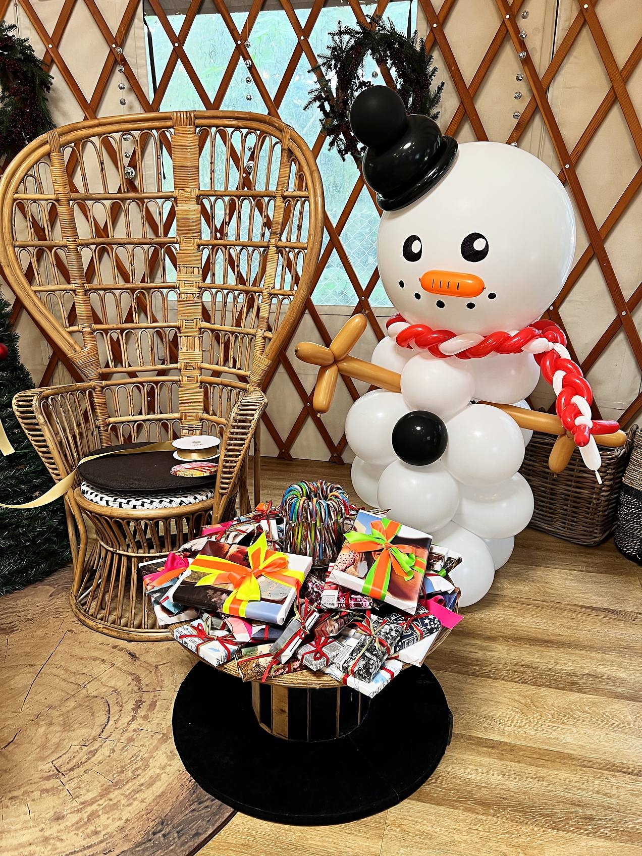 Snowman balloon sculpture with a hat and scarf